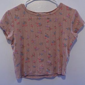 Pinkish beige ish top with pink blue and purple flowers. Kinda coquette.